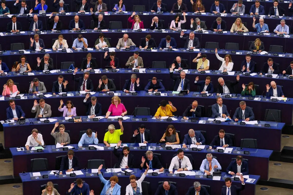 FILE PHOTO: Members of the EU Parliament vote during a plenary session at the European Parliament in Starsbourg, France June 13, 2023. REUTERS/Yves Herman/File Photo