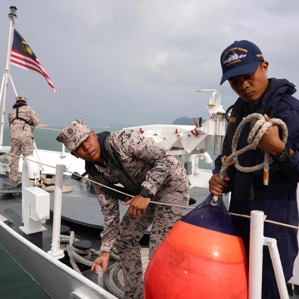 Malaysian Maritime Enforcement Agency officers prepare for the search and rescue operation.