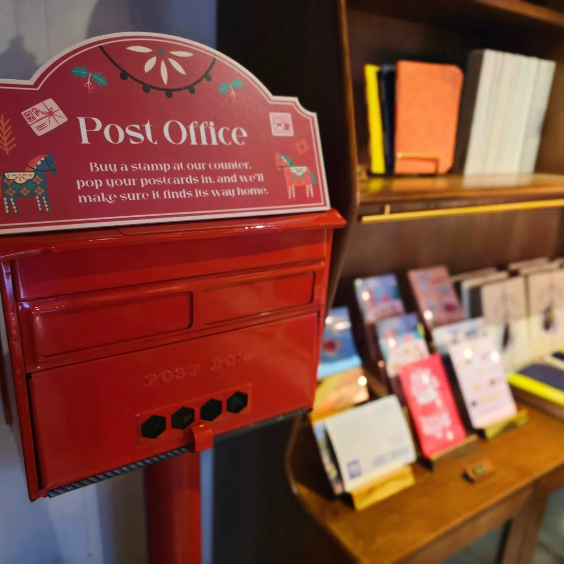 A retro post box sits beside a row of postcards at Books Beyond Borders’ bookshop just across the Maxwell MRT station.

