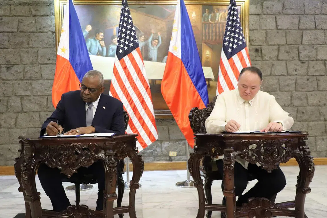 US Defence Secretary Lloyd Austin (left) and his Philippine counterpart, Mr Gilberto Teodoro, sign a new defence pact.