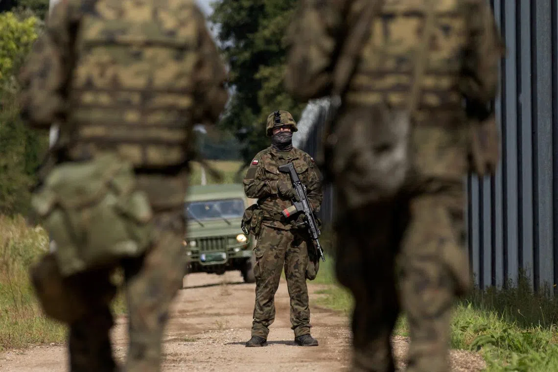 Polish soldiers stand guard at the border with Belarus, amid heightened tensions between the two neighbours over Russia's invasion of Ukraine.