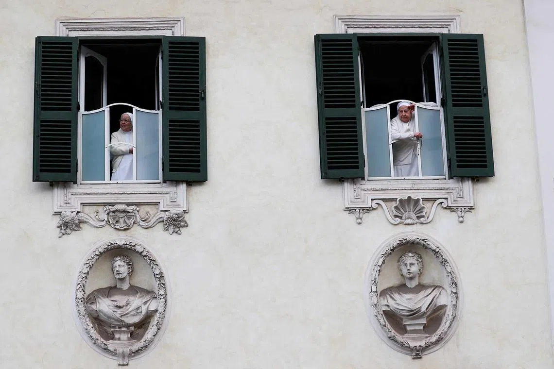 Nuns watch from windows as people demonstrate for peace and against Russia's invasion of Ukraine during a protest, in Rome, Italy, Nov 5, 2022. 