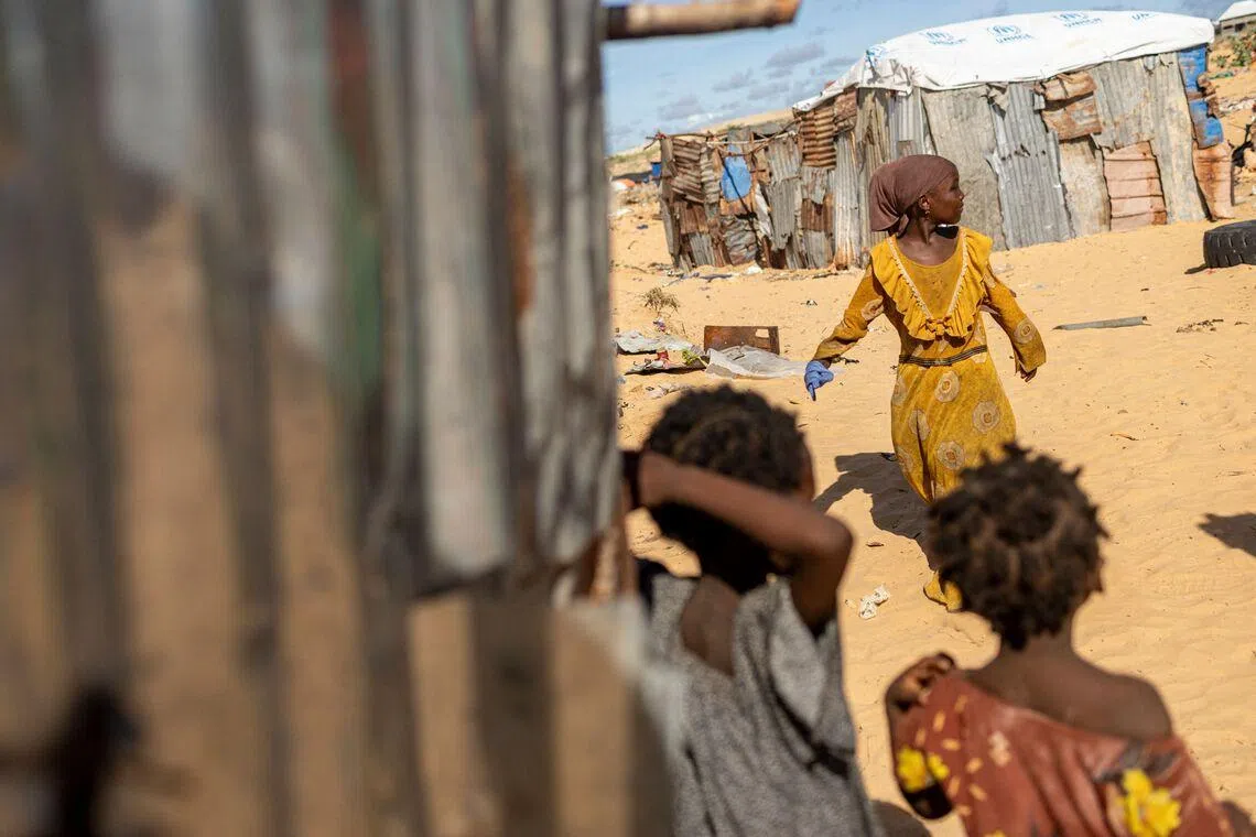 Somali internally displaced children playing near their makeshift shelters at a internally displaced persons (IDP) camo in Ceel Cad, Kismayo town, on April 20, 2026. 