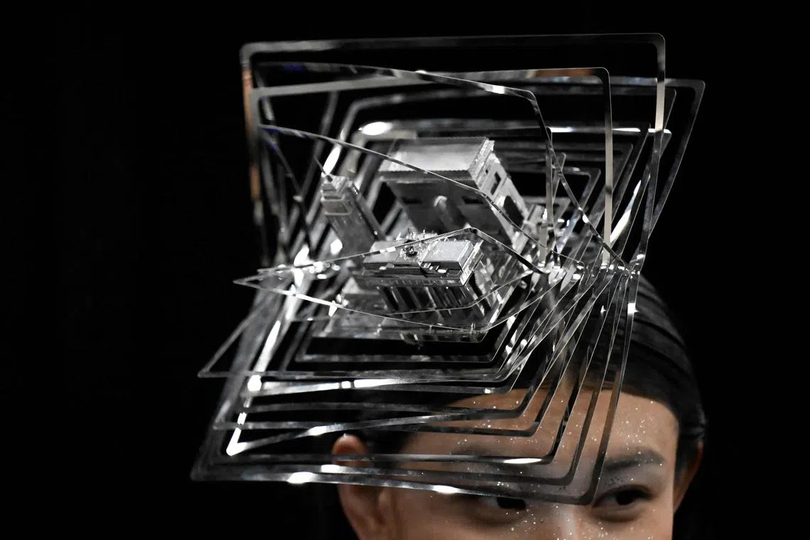 A model prepares backstage before a creation from the Saint Joy by Bian Huizhong during the China Fashion Week in Beijing on March 30.