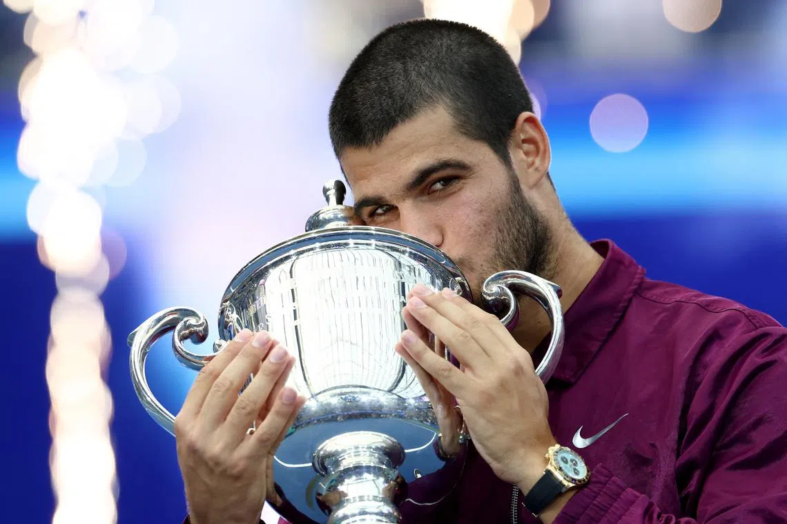 Tennis - U.S. Open - Flushing Meadows, New York, United States - September 7, 2025 Spain's Carlos Alcaraz celebrates with the trophy after winning the men's singles final REUTERS/Kevin Lamarque