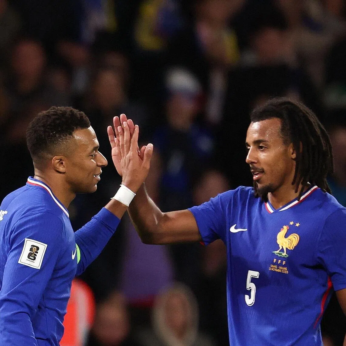France's Kylian Mbappe (left) celebrates scoring his team's third goal with defender Jules Kounde.