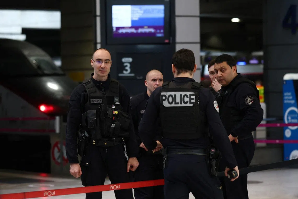 French police secure the area at the Gare Montparnasse train station during its evacuation in Paris in November 2025.