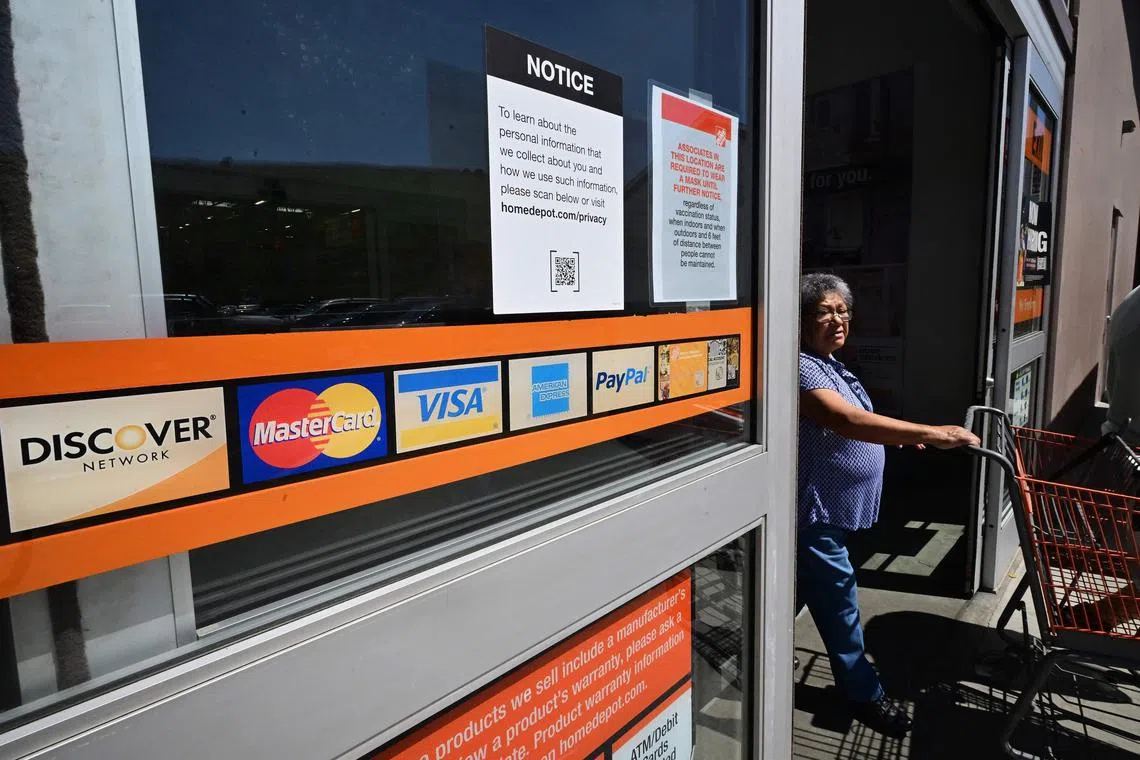 A display of credit cards accepted for use is seen on a door as a shopper steps out of a store on September 12, 2023 in Monterey Park, California. Credit card debt from US consumers is rising by billions of dollars amid higher inflation and interest rates, topping $1 trillion for the first time in history, according to the Federal Reserve Bank of New York. (Photo by Frederic J. BROWN / AFP)