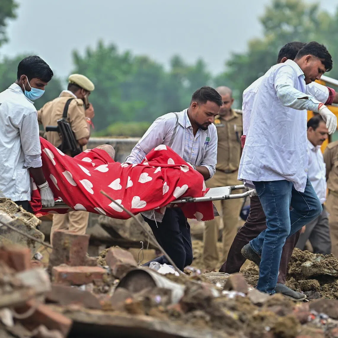 Indian health workers retrieving a body from the rubble, following an Aug 31 explosion at a firecracker factory in India’s Uttar Pradesh state.