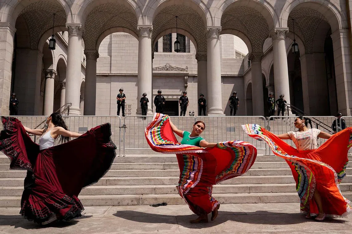 People dancing as they protest against federal immigration sweeps, in downtown Los Angeles, California, US, June 11, 2025. 
