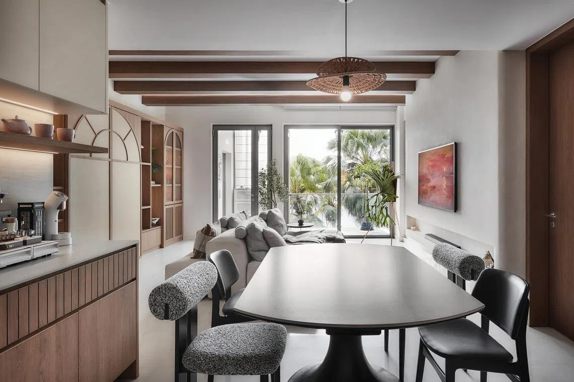 The dining area has a clear view of the greenery outside.