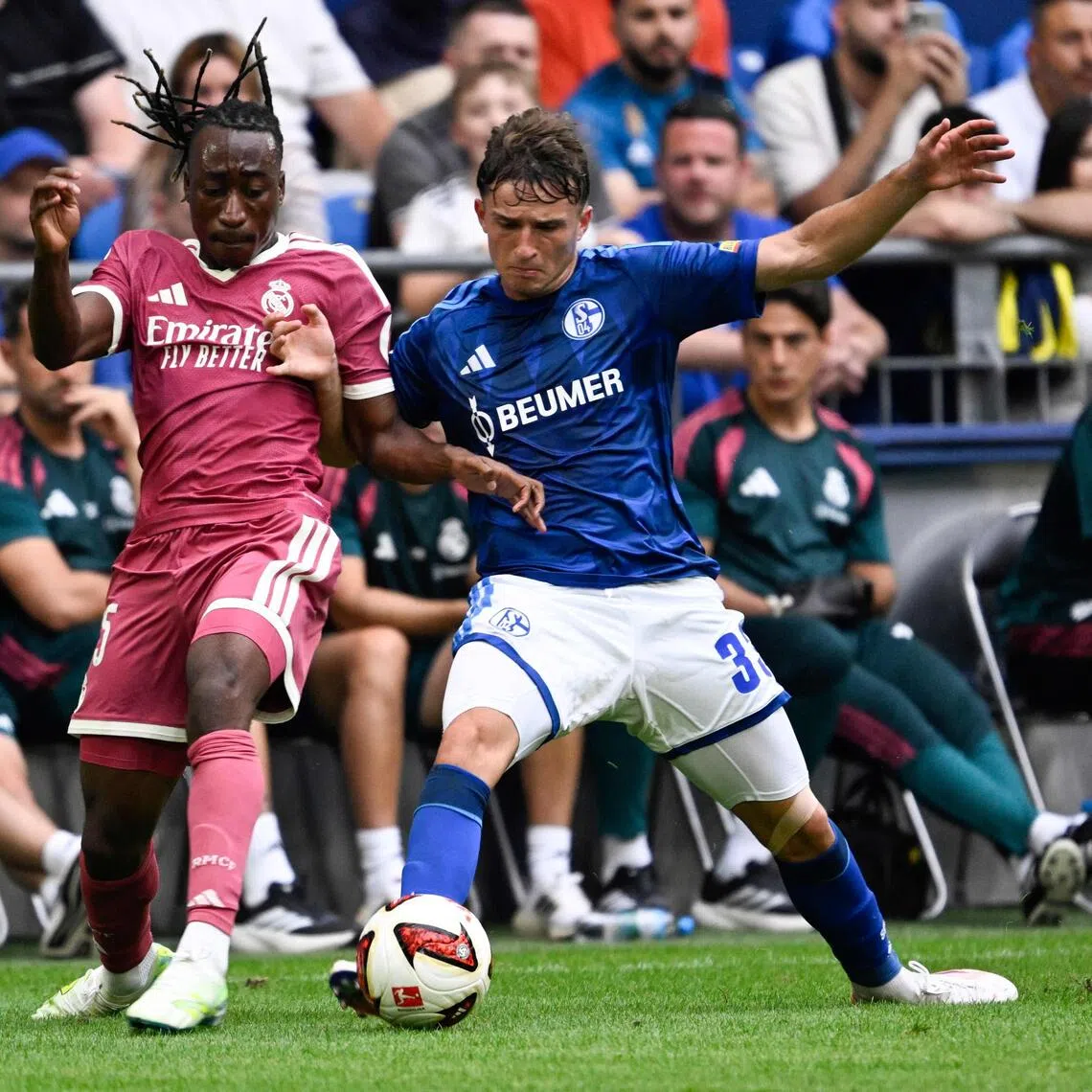 Real Madrid’s Yan Diomande (left) and Schalke’s Vitalie Becker vie for the ball during a friendly football match on Aug 16.