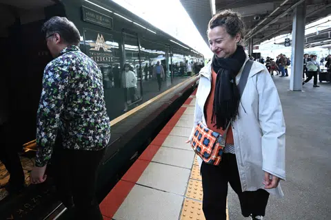 French novelist Muriel Barbery boarding the Mizukaze train at the Shin-Osaka Station, in Japan’s Osaka Prefecture, on Oct 22. She is one of 16 authors who will write the novel - half of whom speak French and half Japanese.