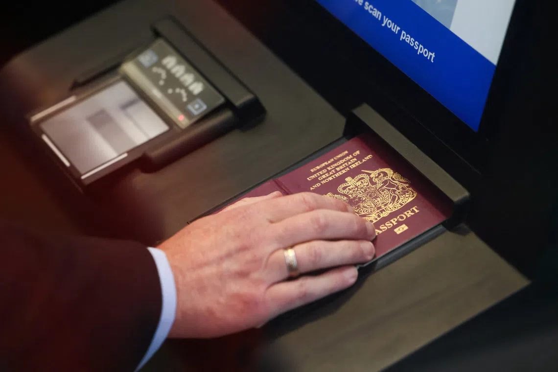 A man scans his passport during a demonstration of the European Union's Entry/Exit System (EES) at the Eurotunnel terminal in Folkestone, Britain, September 23, 2025. REUTERS/Jack Taylor