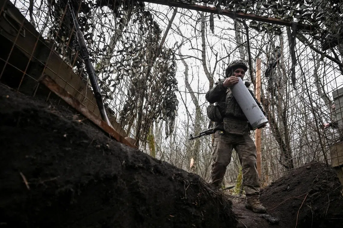 FILE PHOTO: An artilleryman of the 152nd Separate Jaeger Brigade carries a cartridge for a howitzer after firing towards Russian troops, amid Russia's attack on Ukraine, near the frontline town of Pokrovsk in Donetsk region, Ukraine December 11, 2025. REUTERS/Stringer/File Photo