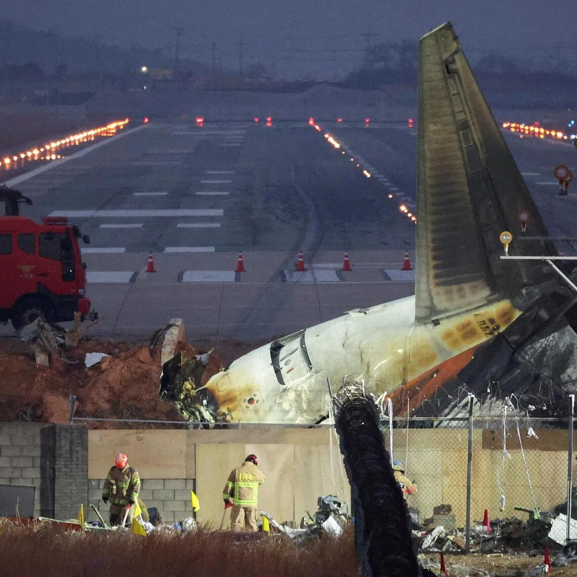 Rescuers work near the wreckage of the Jeju Air aircraft that went off the runway and crashed at Muan International Airport, in Muan, South Korea, on Dec 30, 2024.