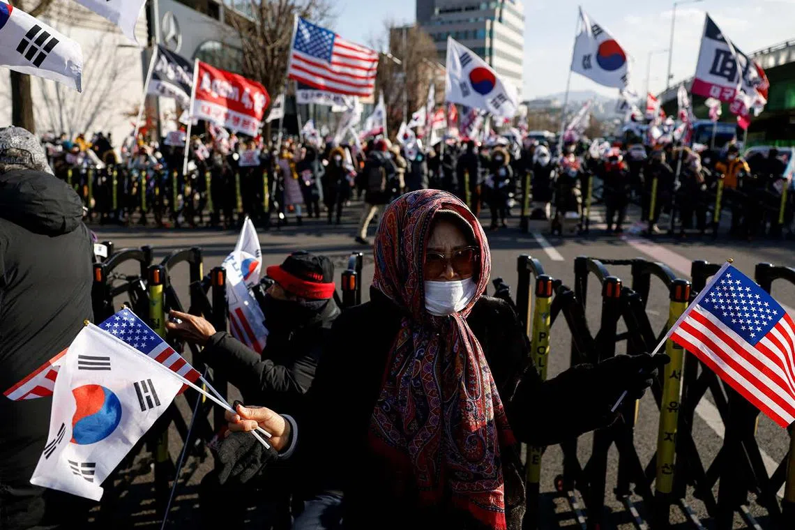 Pro-Yoon demonstrators holding US and Korean flags as they take part in a rally in support of impeached South Korean President Yoon Suk Yeol near his official residence in Seoul, South Korea Jan 9, 2025. 