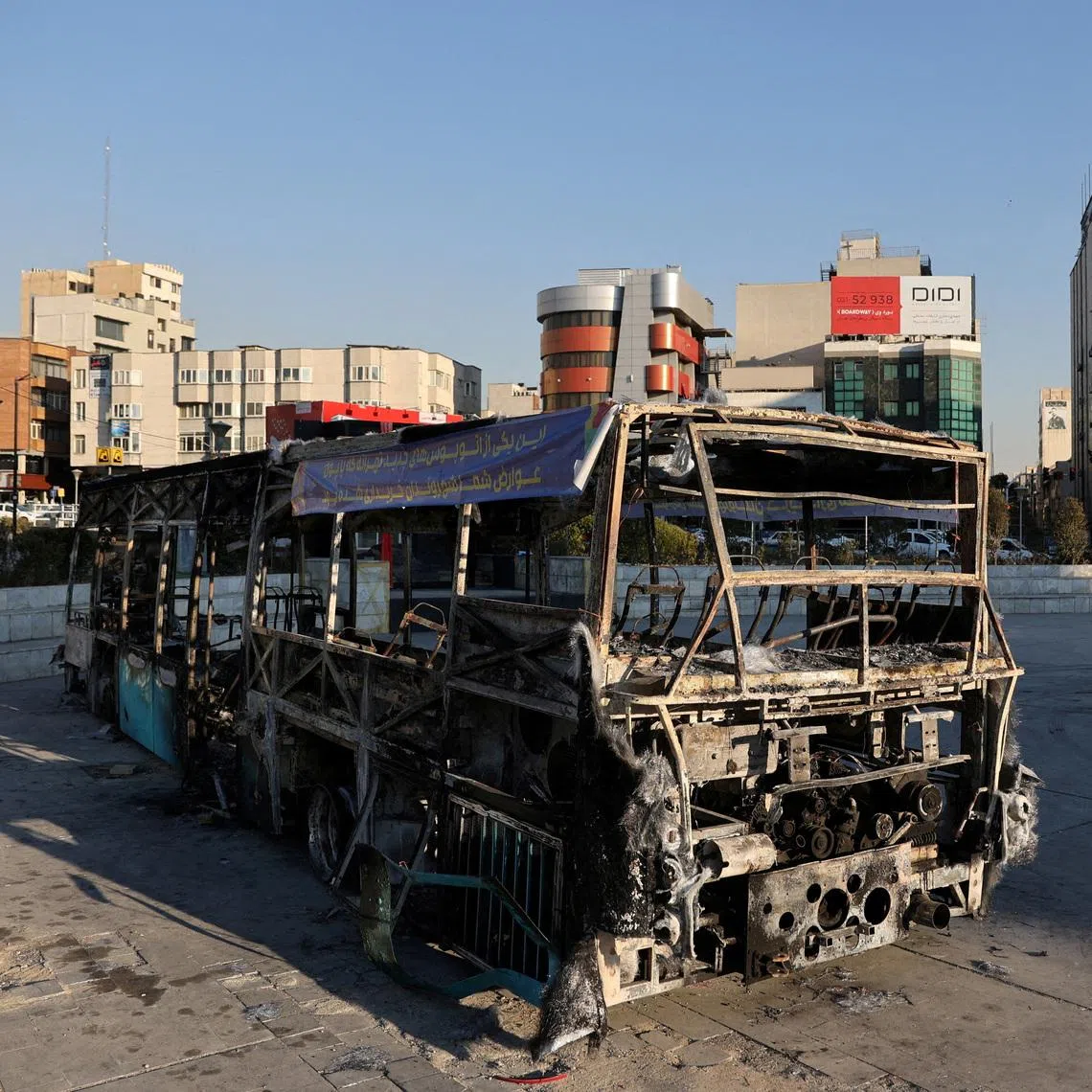 A bus burnt during protests on a street in Tehran on Jan 16.