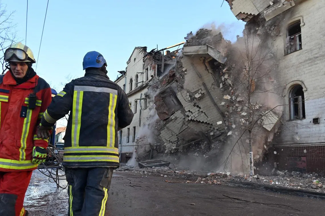 Ukrainian rescuers supervise the dismantling of a residential building that was partially destroyed in a Russian missile attack, in Kharkiv, Ukraine.