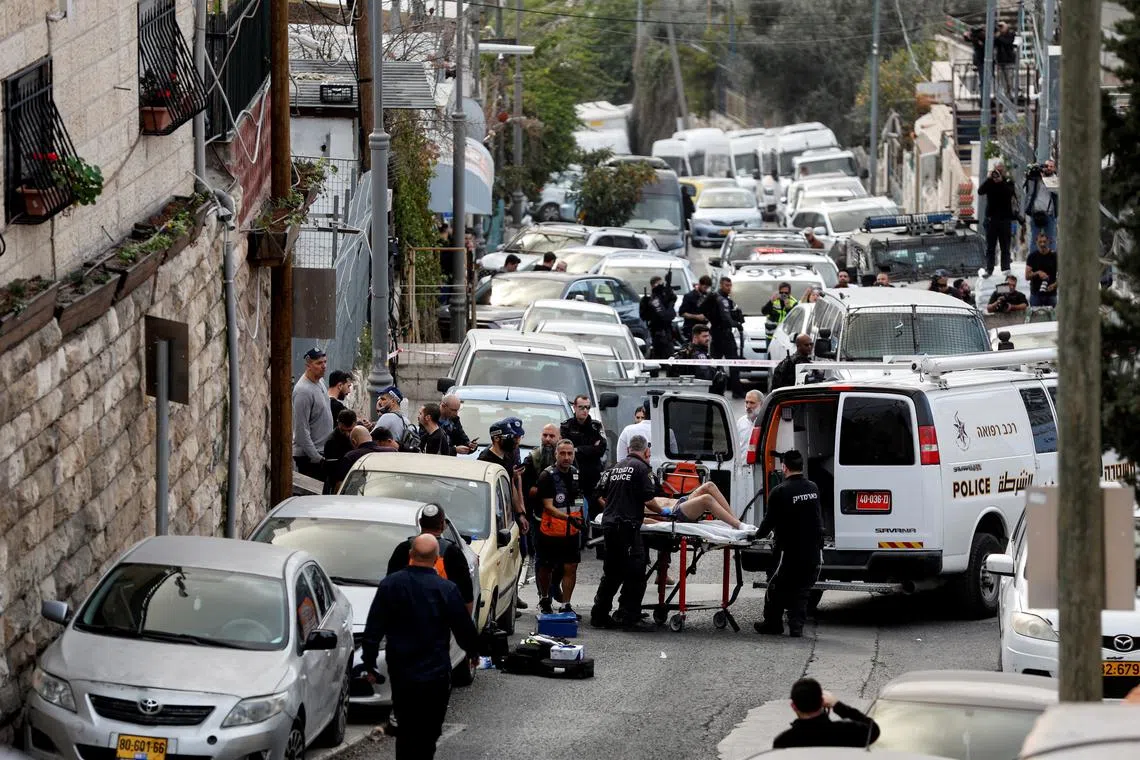 A person is wheeled on a stretcher where a suspected shooting attack took place outside Jerusalem's Old City on Jan 28, 2023.