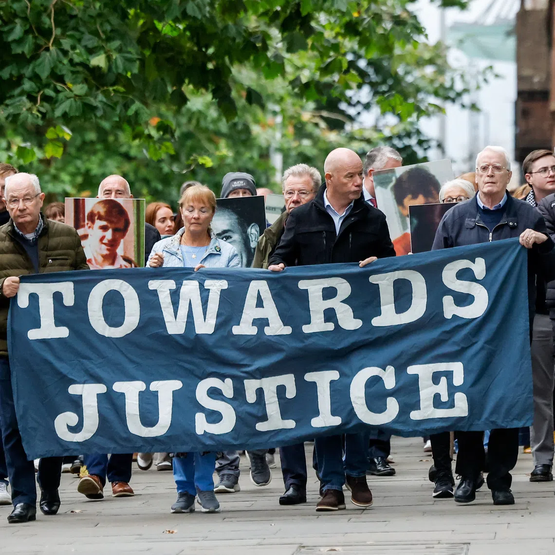 Families of the victims of the 1972 'Bloody Sunday' killings hold a banner, as a judge is expected to rule on the defence application of a dismissal on the trial of the British army veteran known as 'Soldier F', charged with two murders and five attempted murders in relation to Bloody Sunday, in Belfast, Northern Ireland, October 16, 2025. REUTERS/Clodagh Kilcoyne