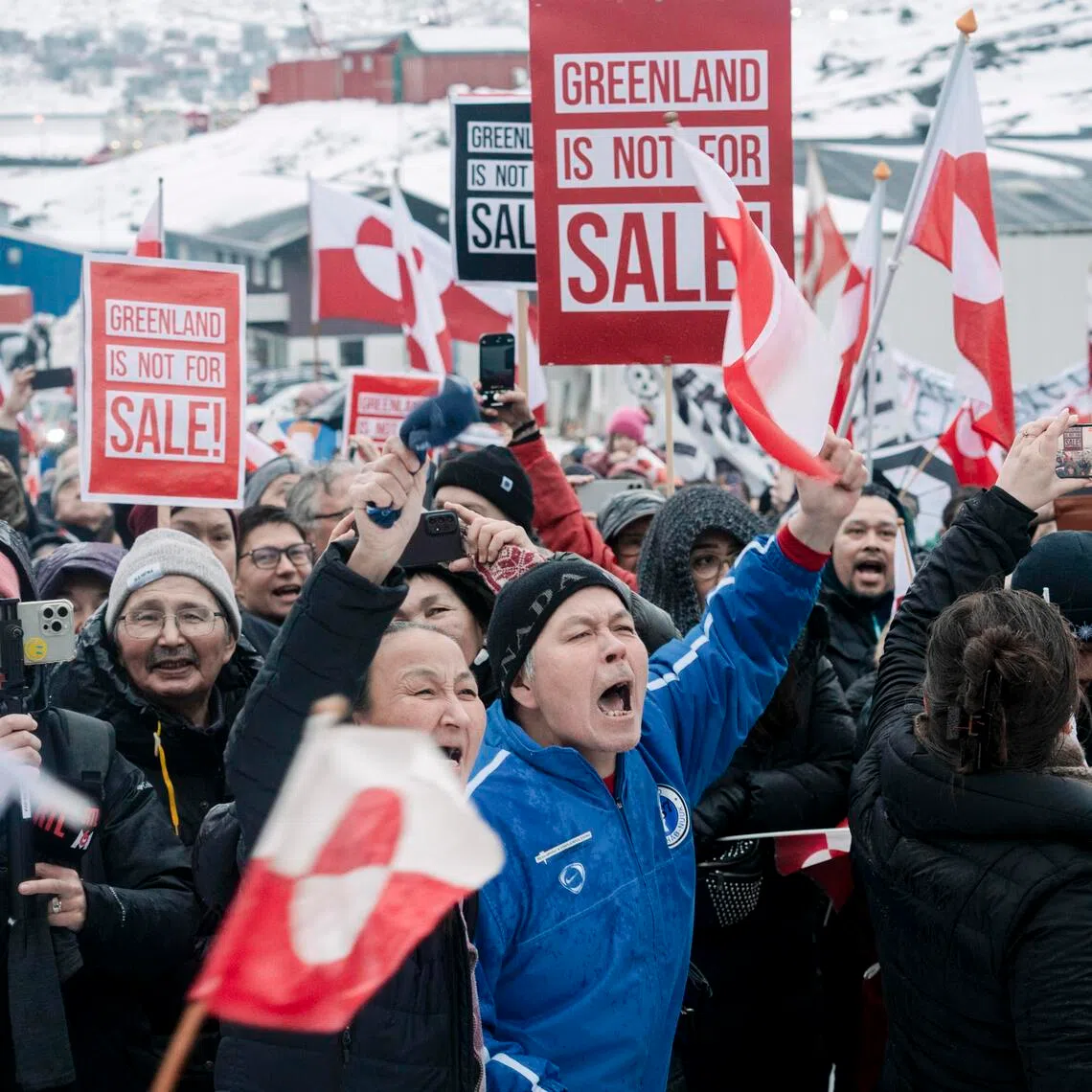 Crowds gather as they wave the flag of Greenland to protest against US President Donald Trump and his proposal to take over the territory.