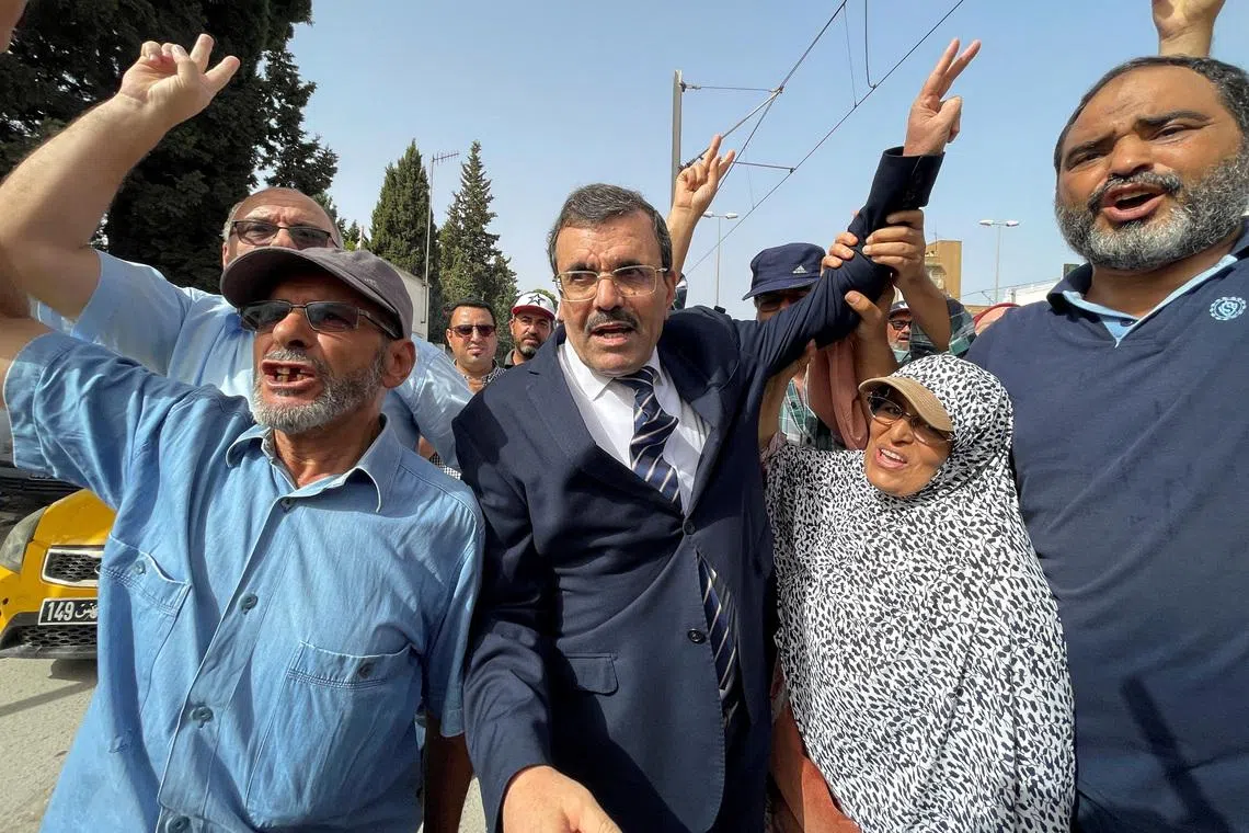 FILE PHOTO: Ali Larayedh, senior official of Tunisia's Islamist opposition party Ennahda and former prime minister, gestures while surrounded by his supporters, upon his arrival for questioning by anti-terrorism police, in Tunis,Tunisia September 19, 2022. REUTERS/Jihed Abidellaoui/File Photo