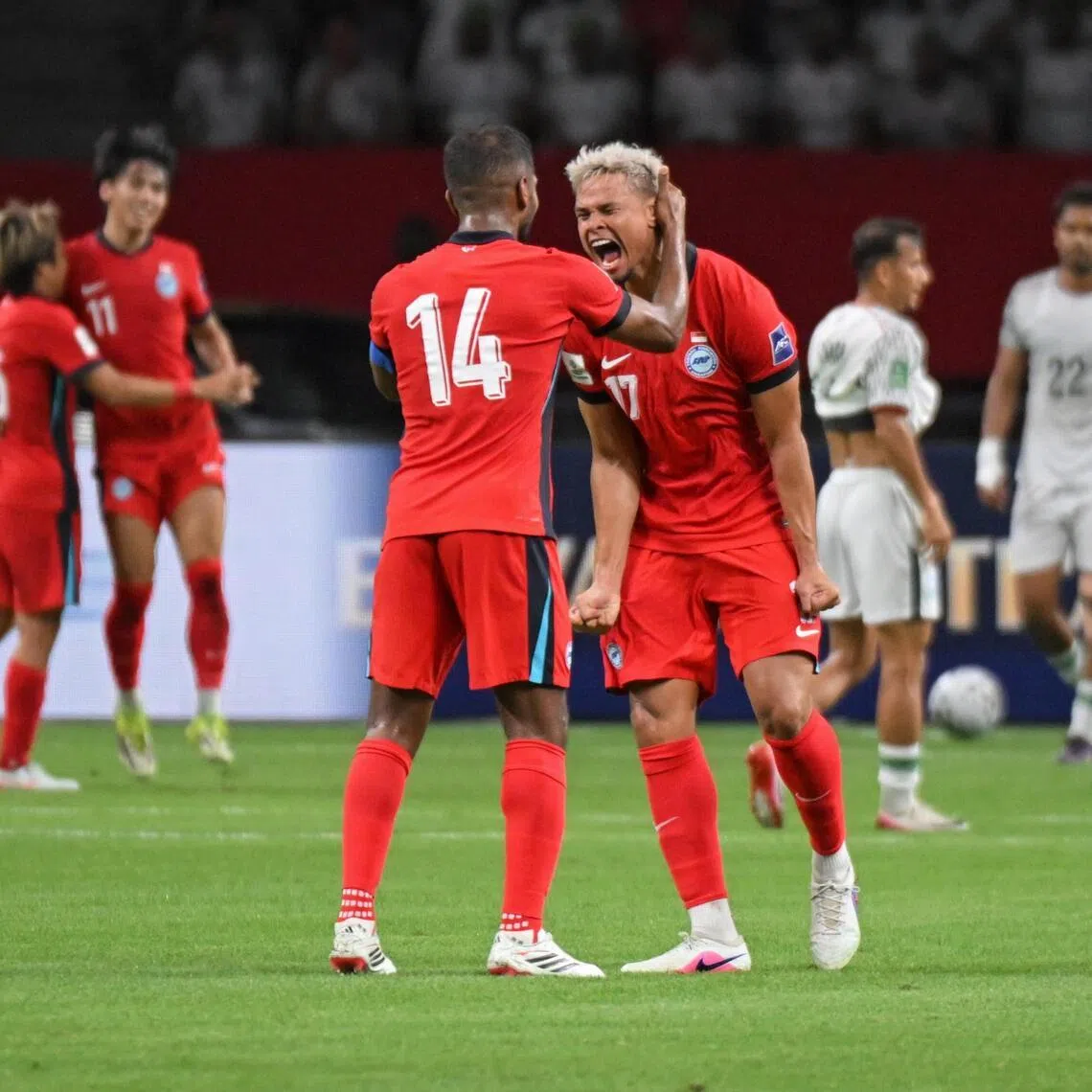 Hariss Harun (back facing) and Irfan Fandi of Singapore celebrate after Harhys Stewart scores the first goal during the AFC Asian Cup qualifier against Bangladesh at the National Stadium on March 31, 2026.