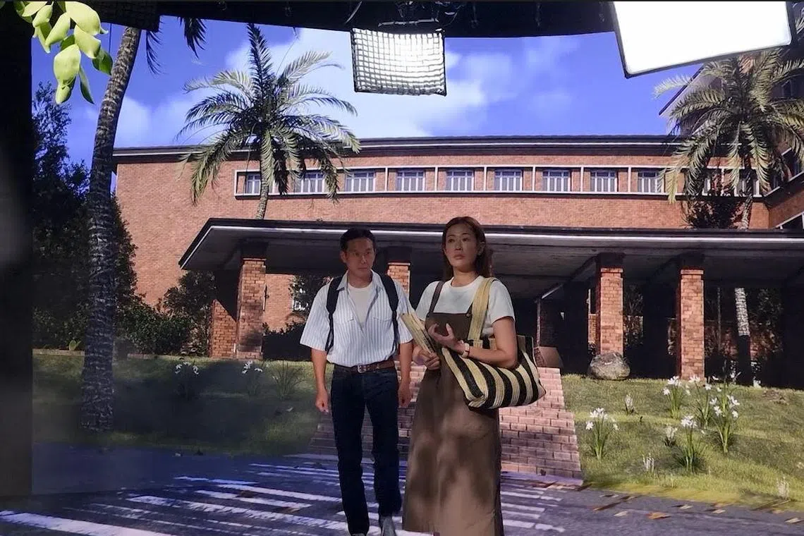 Actor Qi Yuwu and actress Jesseca Liu filming Mediacorp’s upcoming series Once Upon A New Year’s Eve, which uses virtual production to recreate long-gone monuments like the old National Library building in Stamford Road.