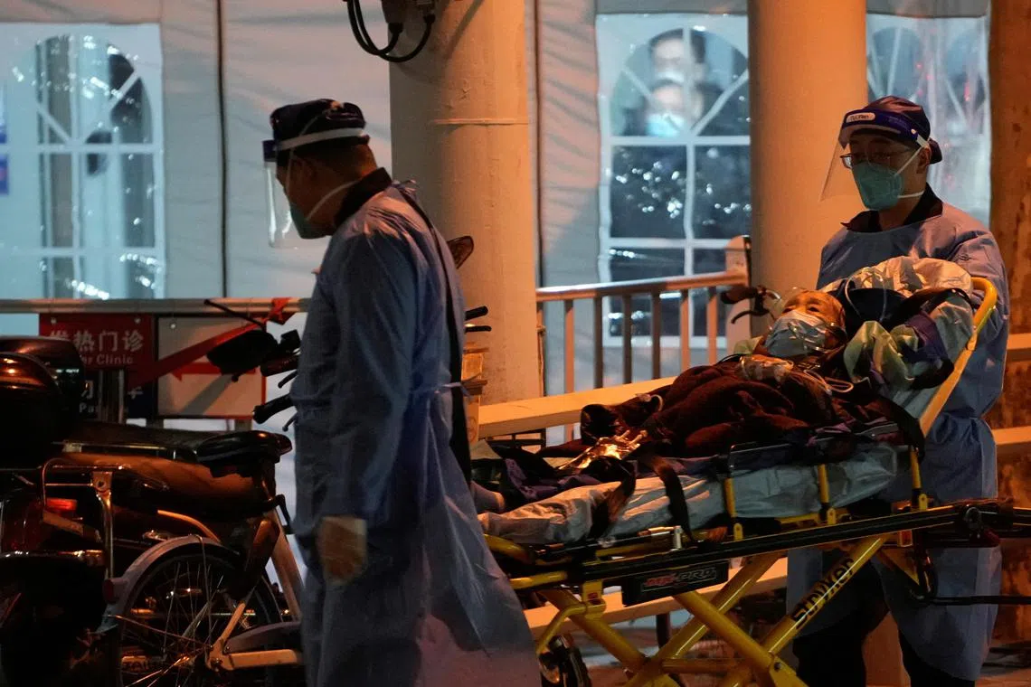 Medical staff moving a patient into a fever clinic at a hospital on Dec 19, as Covid-19 outbreaks continue in Shanghai.