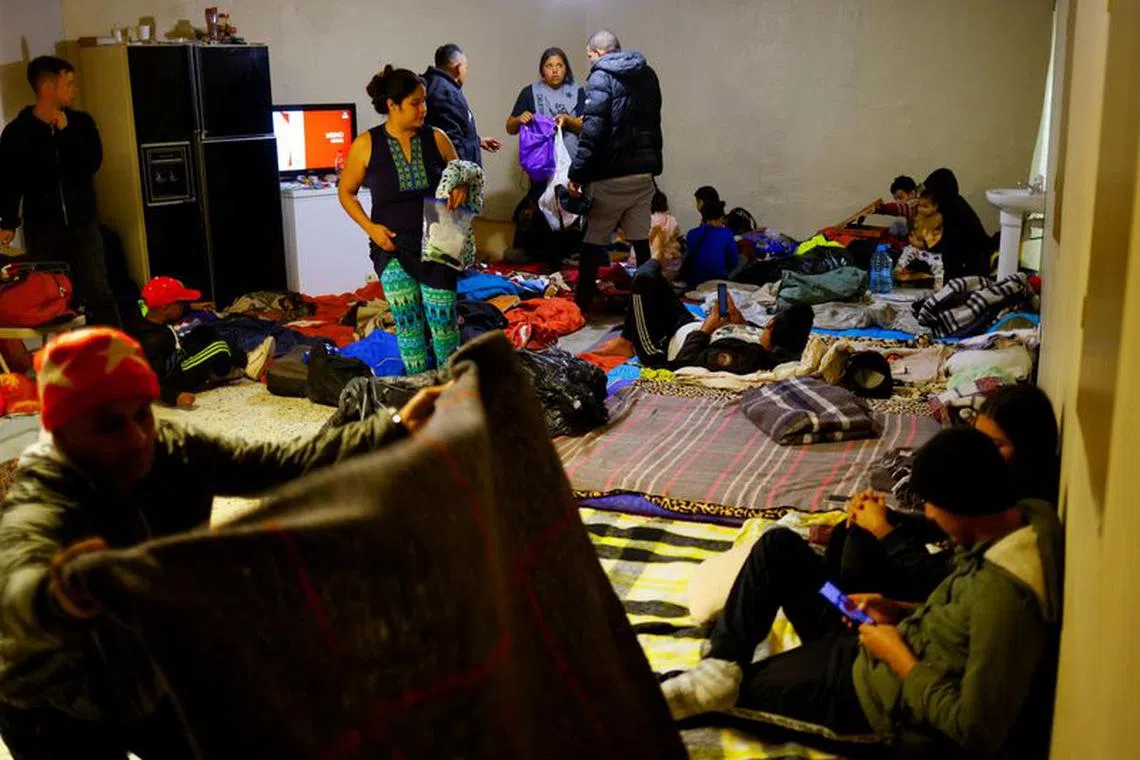 FILE PHOTO: Venezuelan migrants, some expelled from the U.S. to Mexico under Title 42 and others who have not yet crossed after the new immigration policies, rest in an old warehouse that was improvised as a shelter in Ciudad Juarez, Mexico December 1, 2022. REUTERS/Jose Luis Gonzalez/File Photo