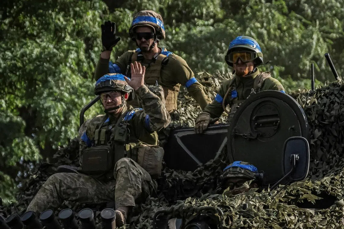 FILE PHOTO: Ukrainian service members ride an Armoured Personnel Carrier, amid Russia's attack on Ukraine, near the Russian border in Sumy region, Ukraine August 11, 2024. REUTERS/Viacheslav Ratynskyi/File Photo