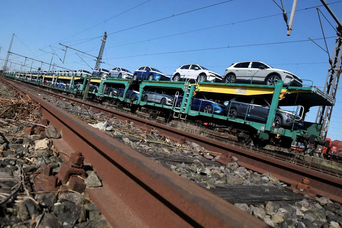 FILE PHOTO: Cars of the Volkswagen Group intended for export to the United States and the United Kingdom sit on train carriages outside the seaport of Emden , Germany, April 2, 2025. REUTERS/Wolfgang Rattay/File Photo