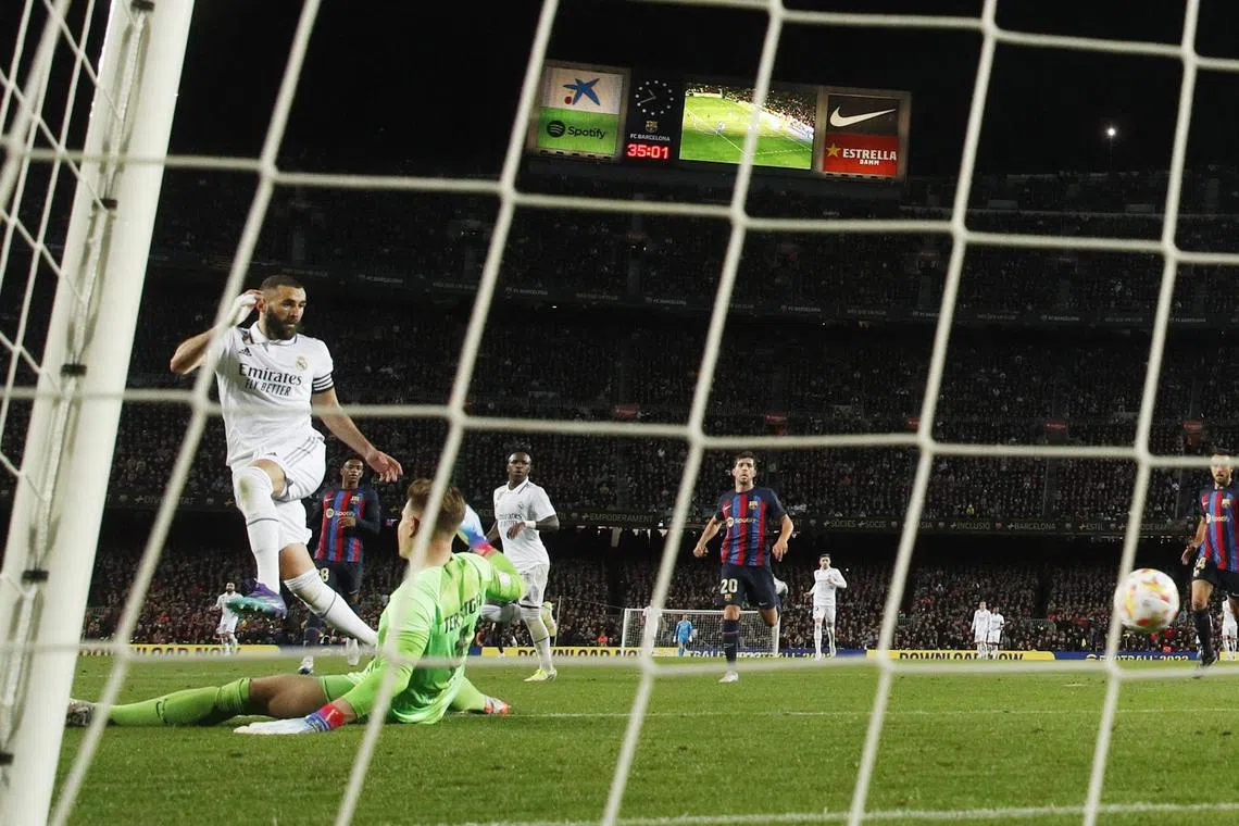 Real Madrid's Karim Benzema scoring their fourth goal against Barcelona to complete his hat-trick in their Copa del Rey tie on Wednesday. 