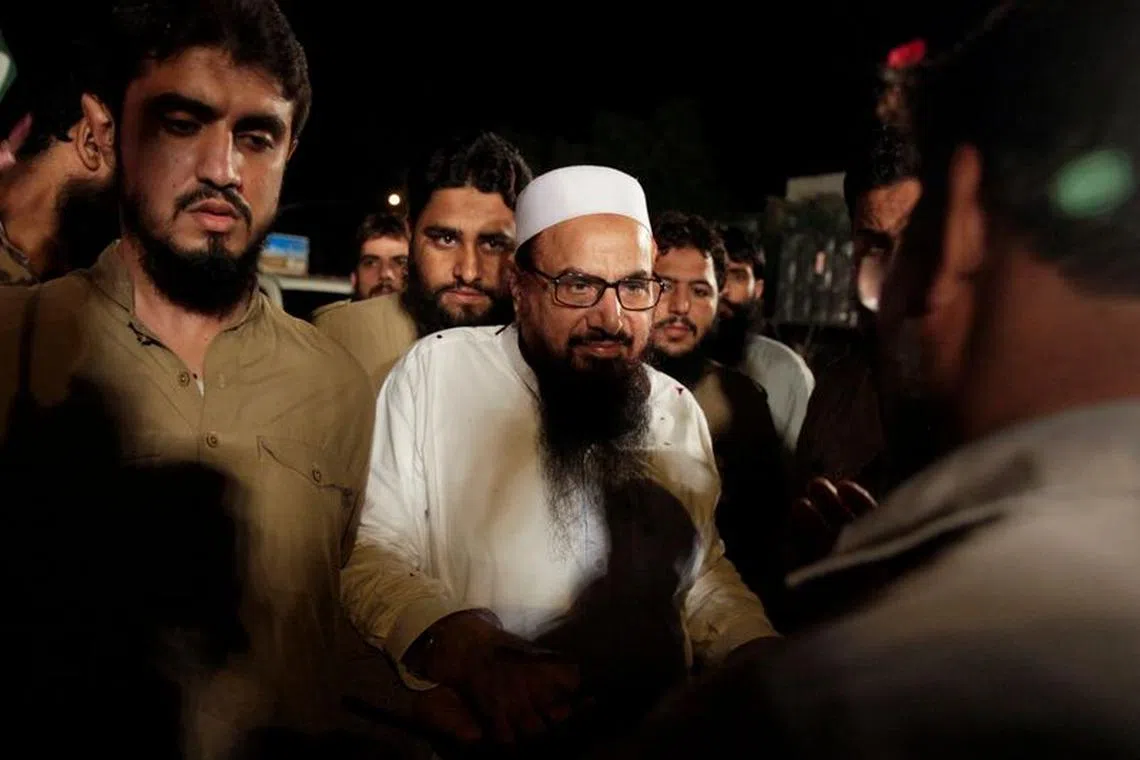 File Photo: Hafiz Muhammad Saeed, chief of the Islamic charity organisation Jamaat-ud-Dawa (JuD), arrives to attend a campaign rally of political party, Milli Muslim League (MML), ahead of general elections in Islamabad, Pakistan July 21, 2018. REUTERS/Faisal Mahmood/File Photo