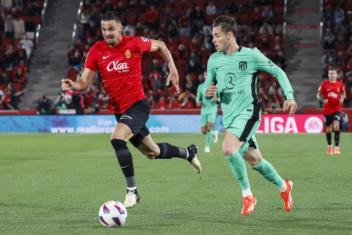 Atletico Madrid's Rodrigo Riquelme (right) fighting for the ball against Mallorca's Martin Valjent in their La Liga match on May 4, 2024.