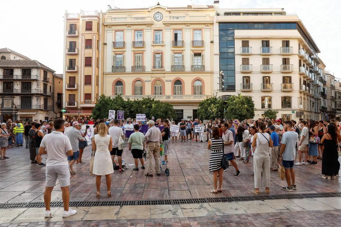 People take part in a protest against Spain's suspended football federation president Luis Rubiales in a square in Malaga.