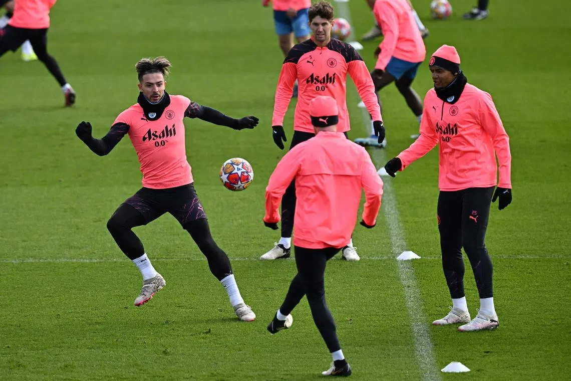 Manchester City's English midfielder Jack Grealish (left) taking part in a session at the club's training ground in north-west England on Feb 12, on the eve of their Champions League round of 16 football match against Copenhagen.