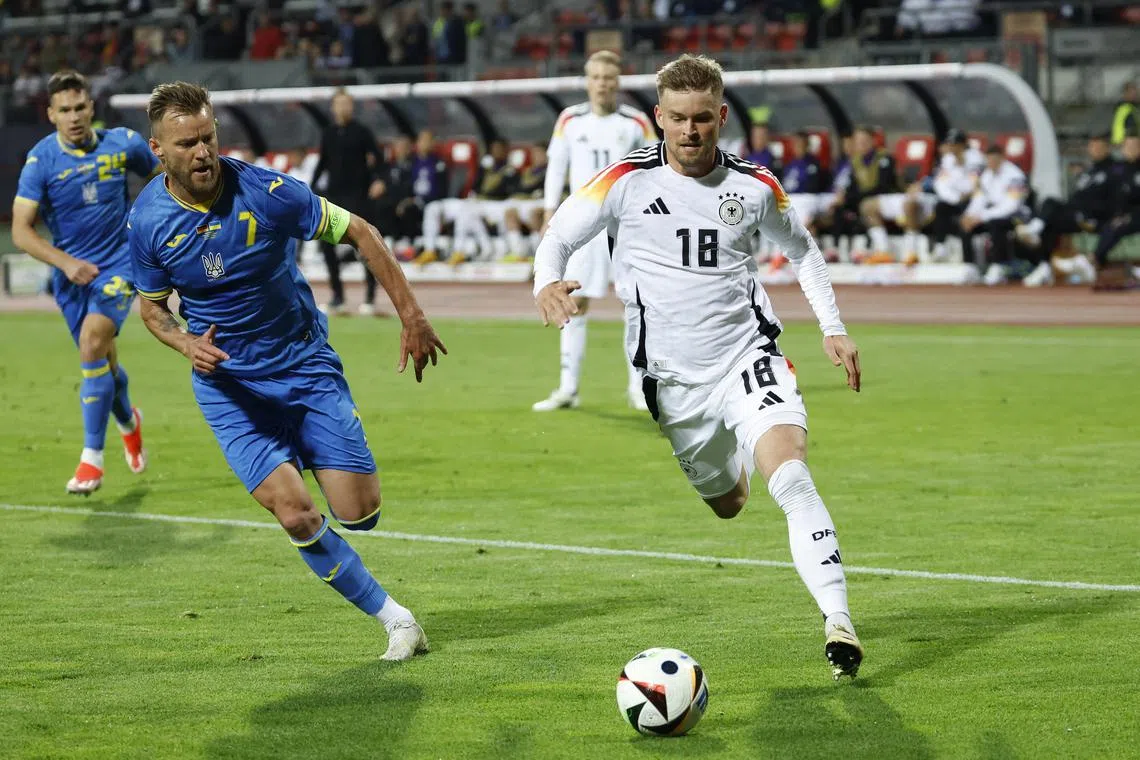 Soccer Football - International Friendly - Germany v Ukraine - Max-Morlock-Stadion, Nuremberg, Germany - June 3, 2024 Germany's Maximilian Mittelstadt in action with Ukraine's Andriy Yarmolenko REUTERS/Heiko Becker