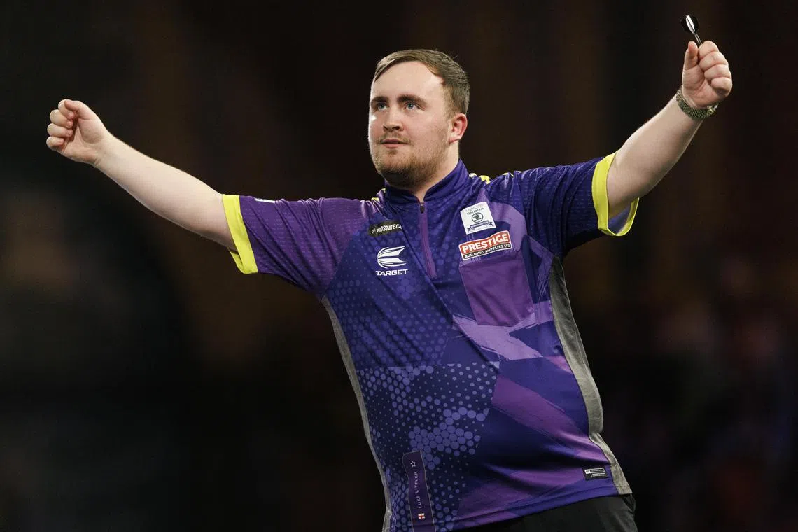 Luke Littler of England celebrating after beating compatriot Rob Cross in the semi-finals of the World Darts Championship in London.