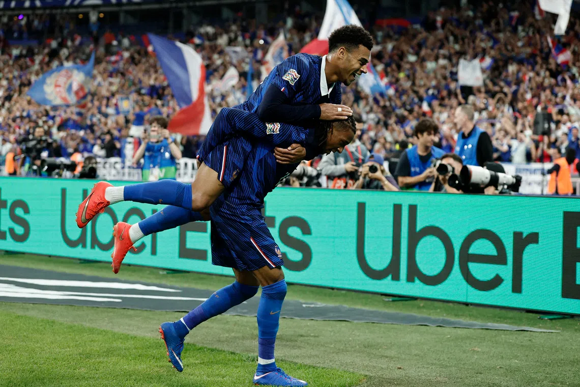 France’s Michael Olise celebrates scoring their third goal against the Belgians with Desire Doue in the Nations League Group A1 match on Oct 5.