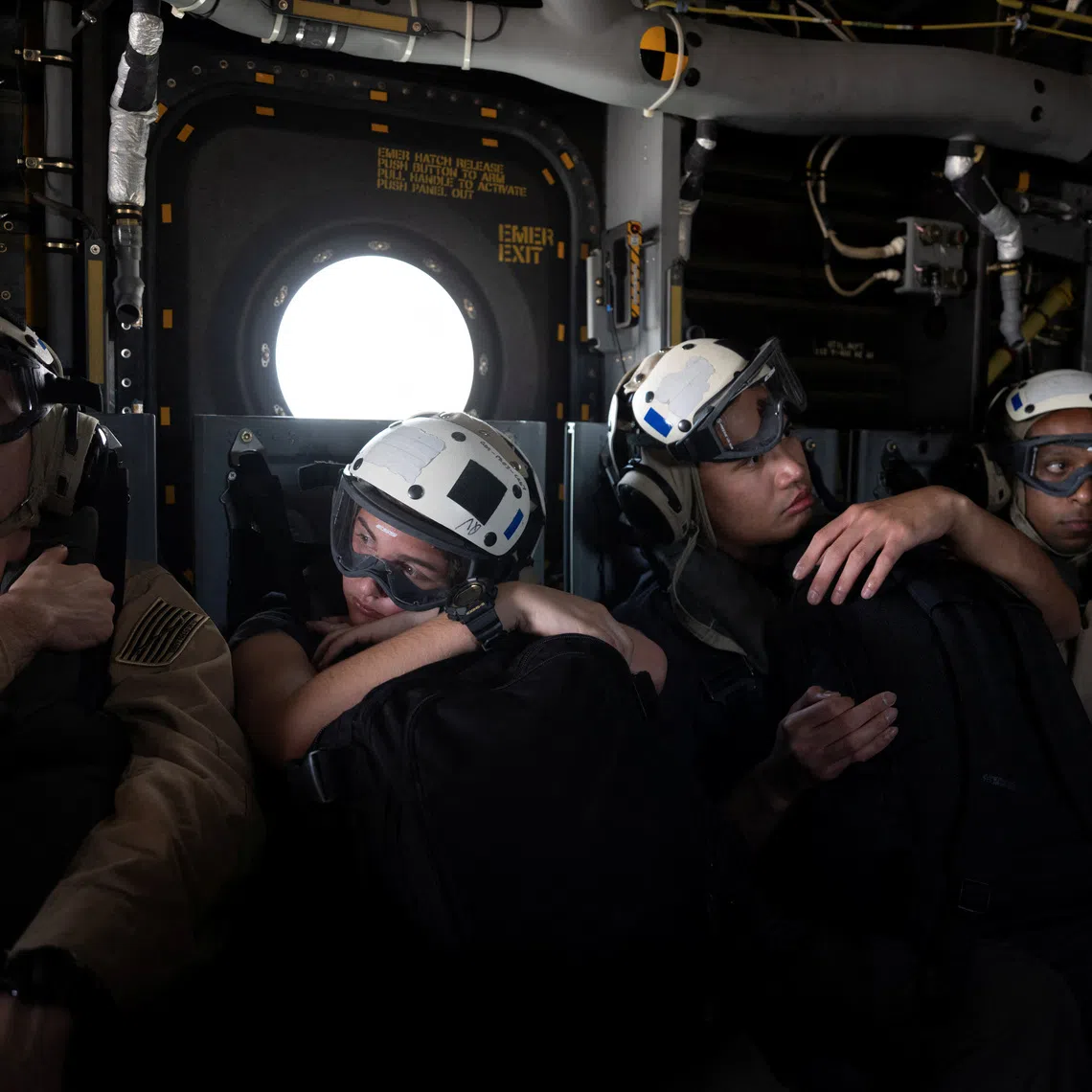 US Navy sailors aboard an MV-22 Osprey travel to the Nimitz-class aircraft carrier USS George Washington in the Arabian Sea, September 11, 2026. The aircraft carrier, capable of carrying more than 5,000 personnel, is enforcing a US naval blockade against Iran and providing cover for commercial vessels transiting the Strait of Hormuz.  REUTERS/Ed Ou