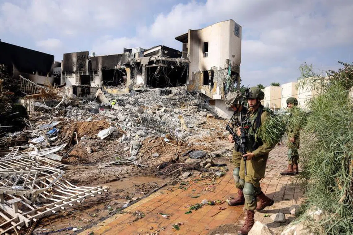 Israeli soldiers patrol outside a police station which was the site of a battle following a mass infiltration by Hamas gunmen from the Gaza Strip, in Sderot, southern Israel October 8, 2023. REUTERS/Ronen Zvulun/File Photo