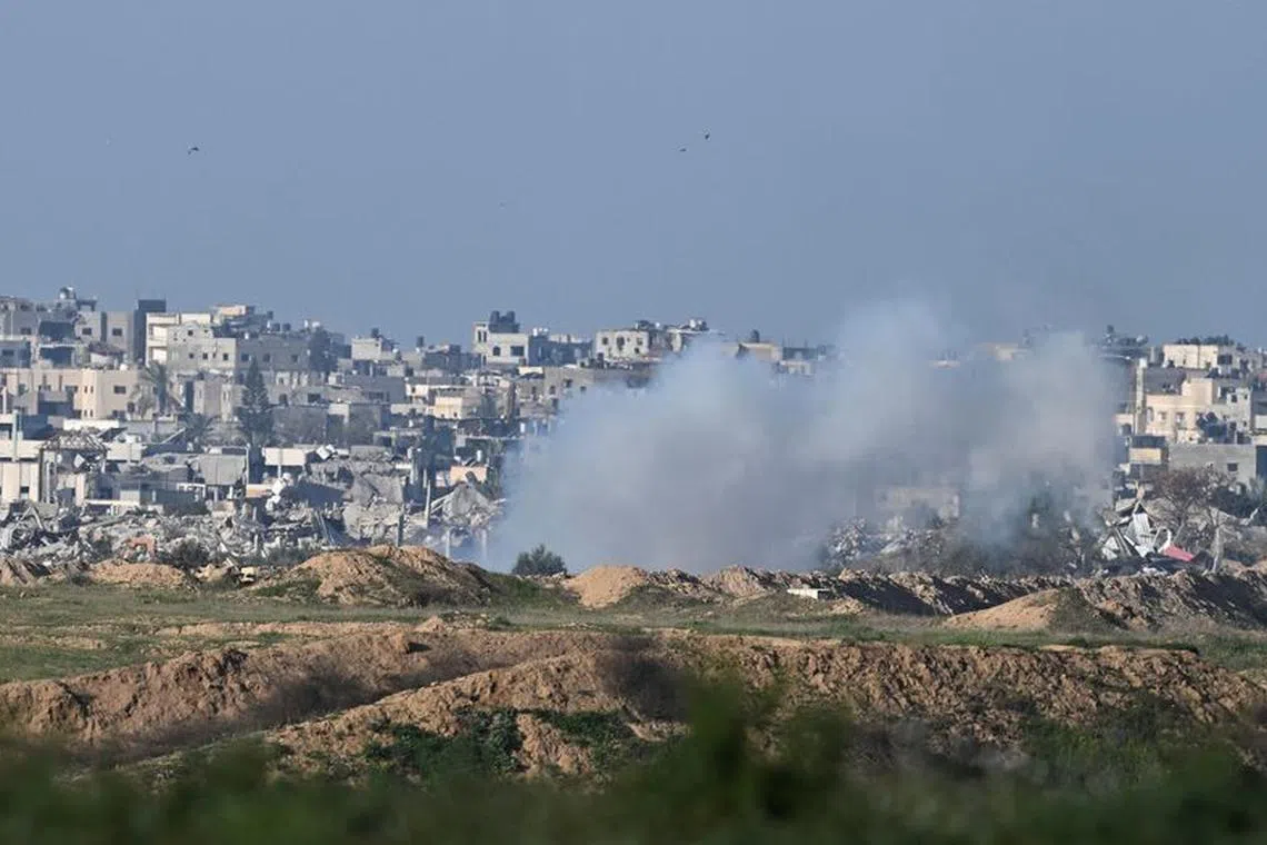 Smoke rises in central Gaza, amid the ongoing conflict between Israel and the Palestinian Islamist group Hamas, near the Israel-Gaza border, as seen from Israel, February 14, 2024. REUTERS/Dylan Martinez