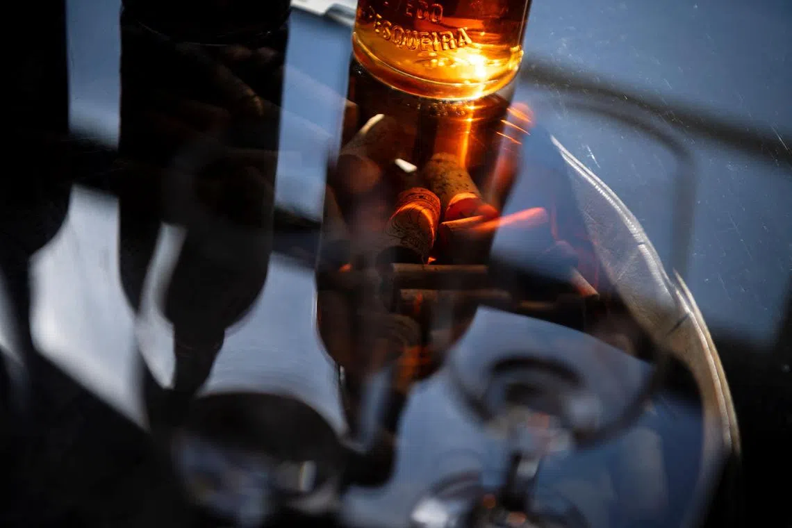 A picture taken on September 30, 2024 shows a bottle of Porto wine in a shop in Vila Nova de Gaia, northern Portugal. The Douro Valley's winegrowers struggle as their famous Porto wine is hit by an unprecedented crisis caused by declining consumption. (Photo by MIGUEL RIOPA / AFP)