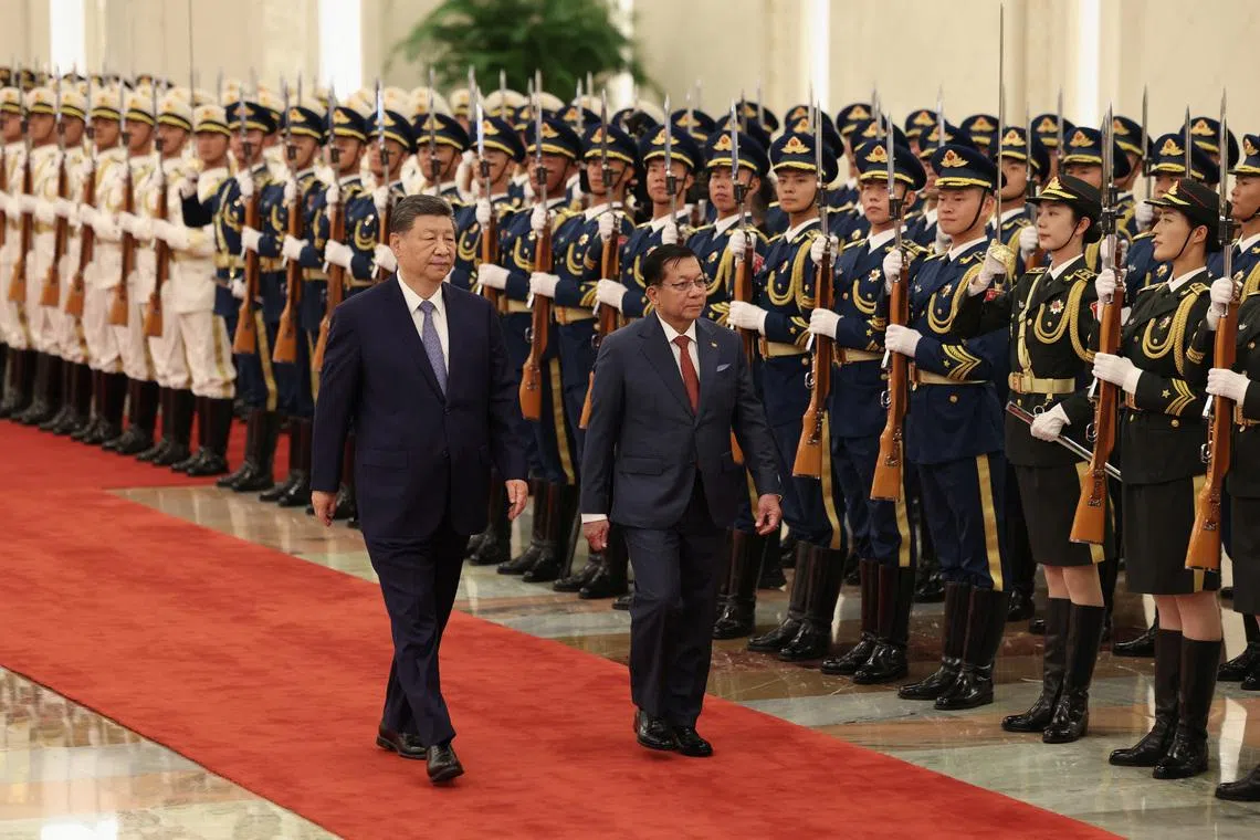 Chinese President Xi Jinping (left) and Myanmar's President Min Aung Hlaing attend a welcoming ceremony at the Great Hall of the People on June 16 in Beijing, China.