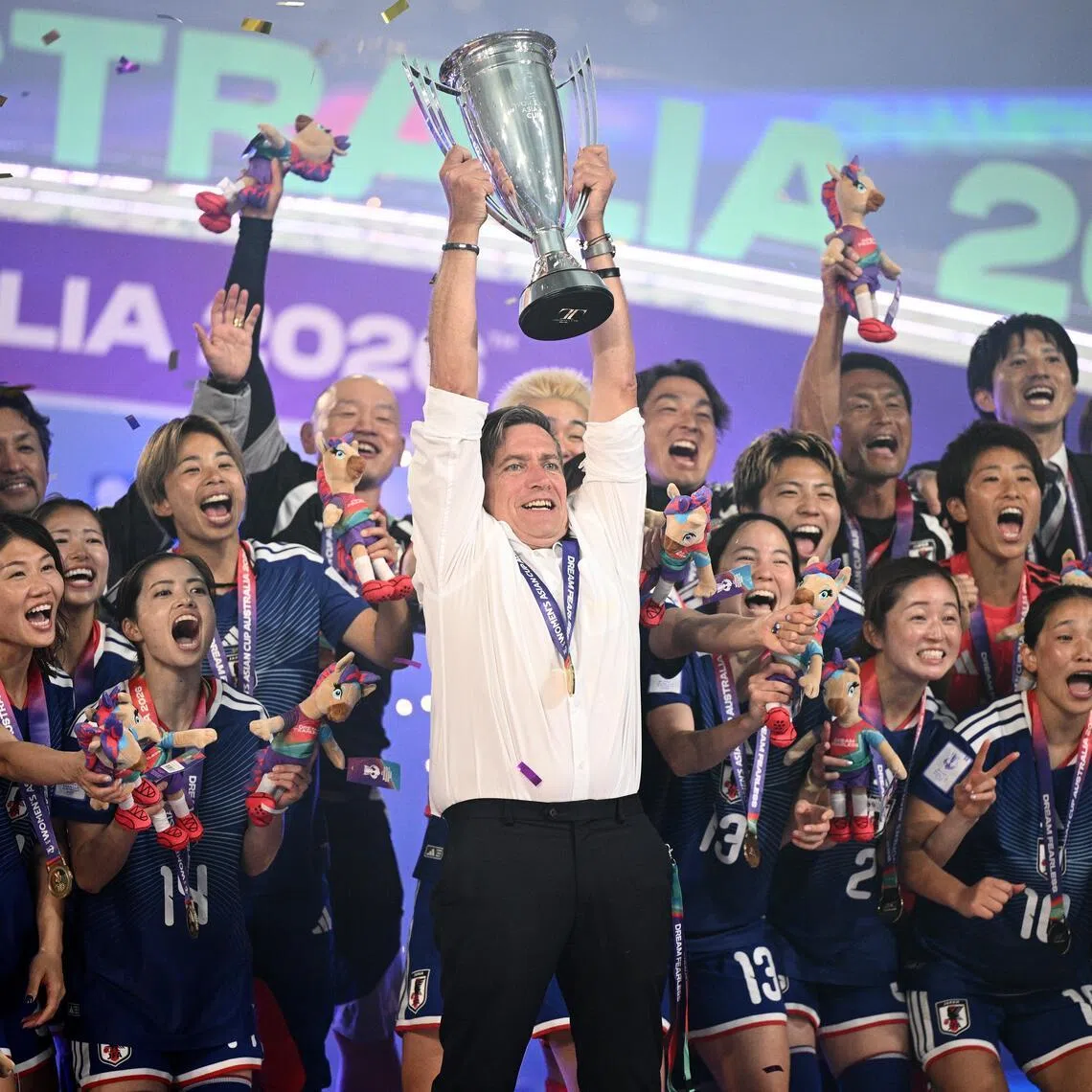 Outgoing Japan coach Nils Nielsen lifting the trophy as Japan celebrate winning the Women’s Asian Cup after beating hosts Australia 1-0 at Stadium Australia in Sydney on March 21, 2026.