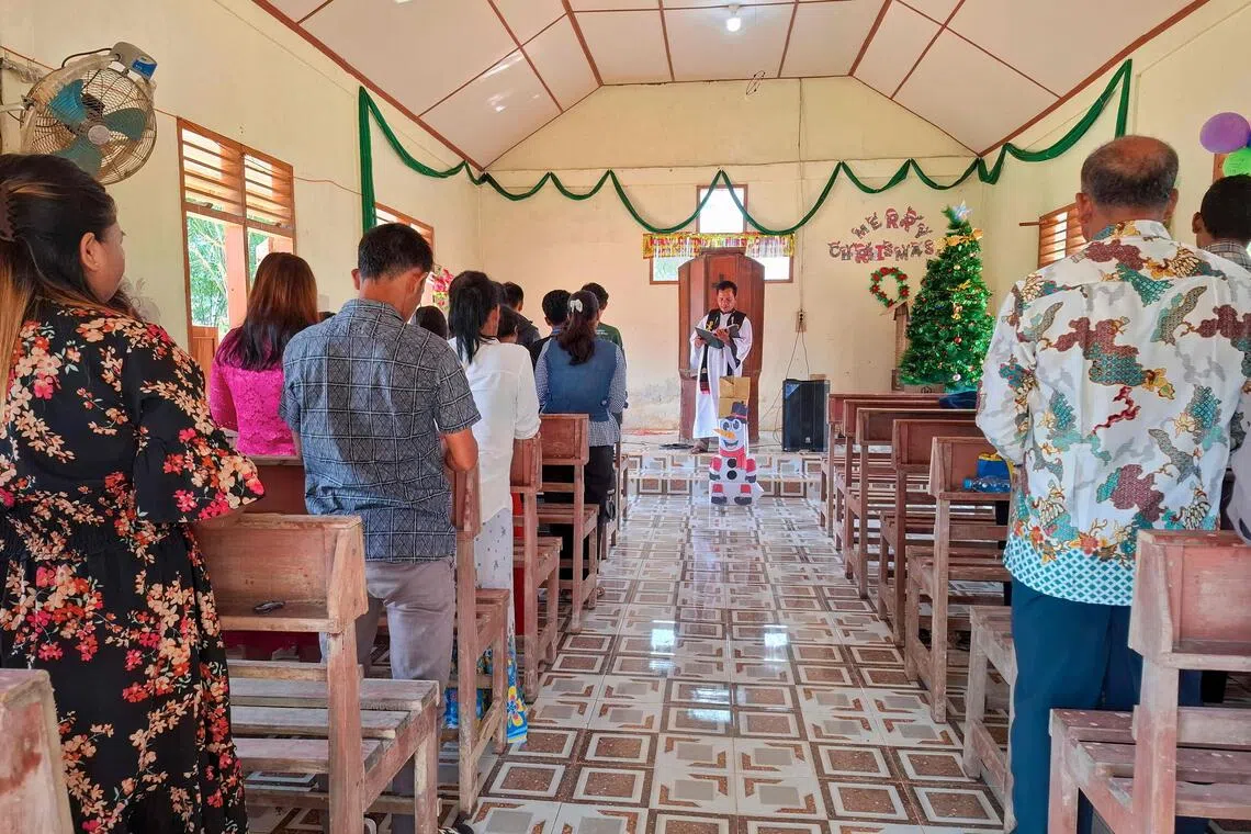Villagers at Christmas Mass at the Angkola Protestant Church at Aek Ngadol village, South Tapanuli in the aftermath of massive flooding and landslides in the area. 
