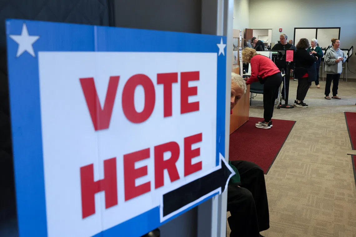 People cast ballots and register inside the Medina County Board of Elections in Ohio on Oct 6.