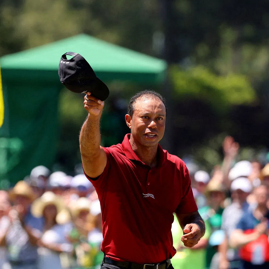 FILE PHOTO: Golf - The Masters - Augusta National Golf Club, Augusta, Georgia, U.S. - April 14, 2024 Tiger Woods of the U.S. acknowledges the crowd on the green on the 18th hole after completing his final round REUTERS/Mike Blake/File Photo